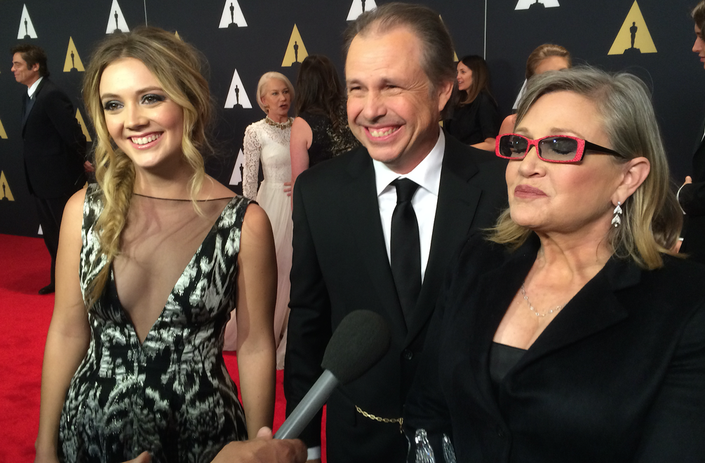 Accepting the award for Debbie Reynolds was her granddaughter Billie Lourd (L), her father and mother, Carrie Fisher (R).