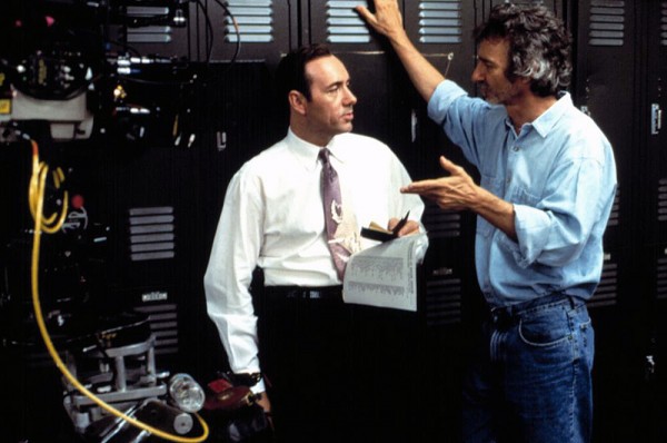Curtis Hanson (Right) talks with Kevin Spacey (Center) on the set of LA Confidential