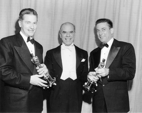Elmo Williams (L)and Harry Gerstad (R)< receiving the Academy Award in Editing for "High Noon", from Frank Capra (C).