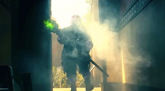 peter-dinklage-s-toxic-avenger-stands-in-a-doorway-wielding-a-mop-in-the-toxic-avenger-2025